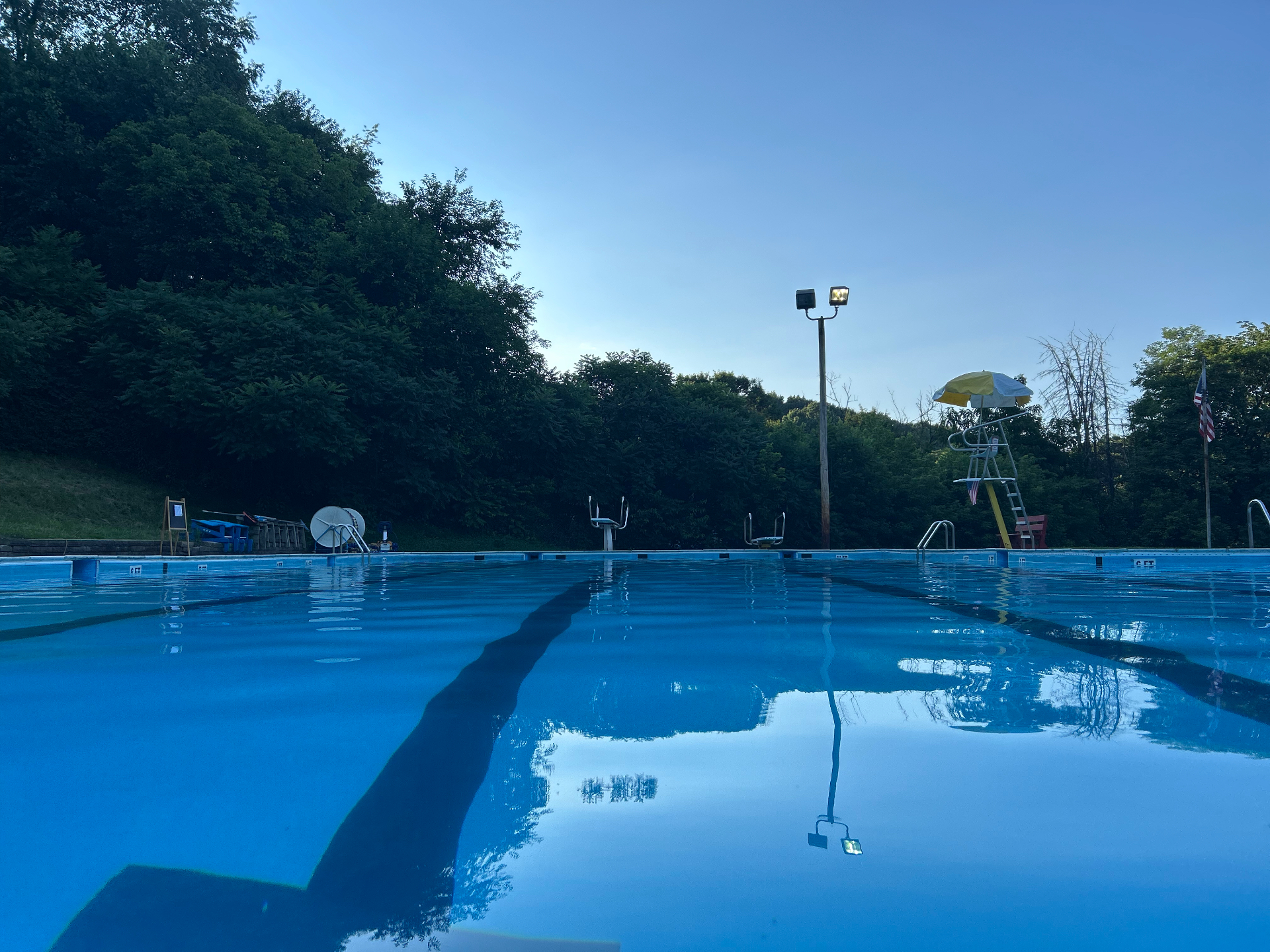 Evening view of Petrarca Memorial Pool with calm water and the lifeguard stand